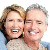 a couple with distinctive smiles after completing dental Implants, Willow Prescott AZ