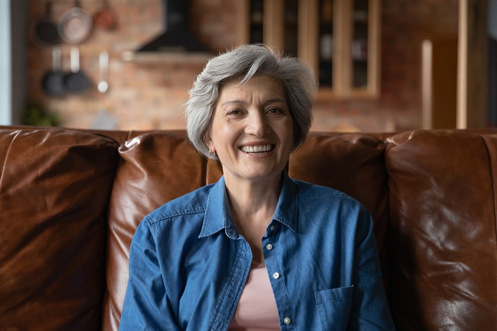Older woman smiling confidently at home, representing restored quality of life after teeth-in-a-day implant treatment at Prescott Dental Arts in Prescott, AZ