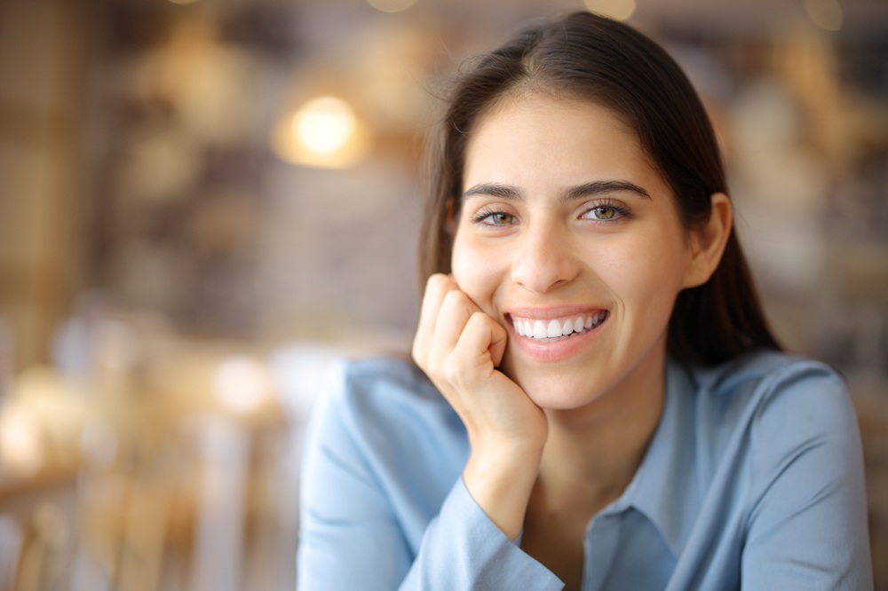 Woman smiling confidently with bright, healthy teeth, representing cosmetic dentistry results at Prescott Dental Arts in Prescott, AZ