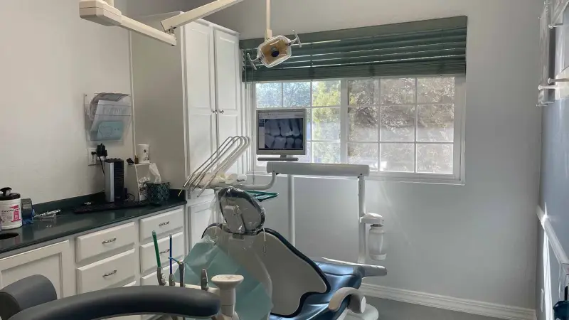 Dental Treatment Room, Prescott Dental Arts Prescott AZ Modern dental treatment room at Prescott Dental Arts in Prescott, AZ, featuring a patient chair, overhead operatory light, and chairside monitor displaying dental x-rays